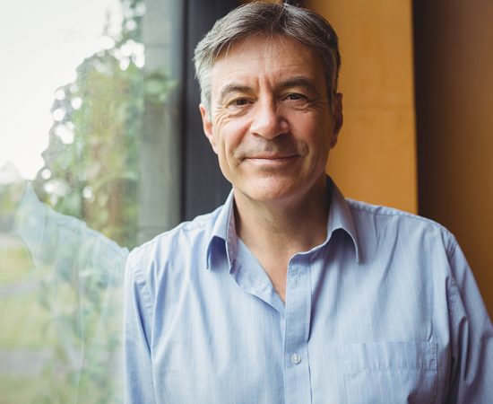 Man smiling from window